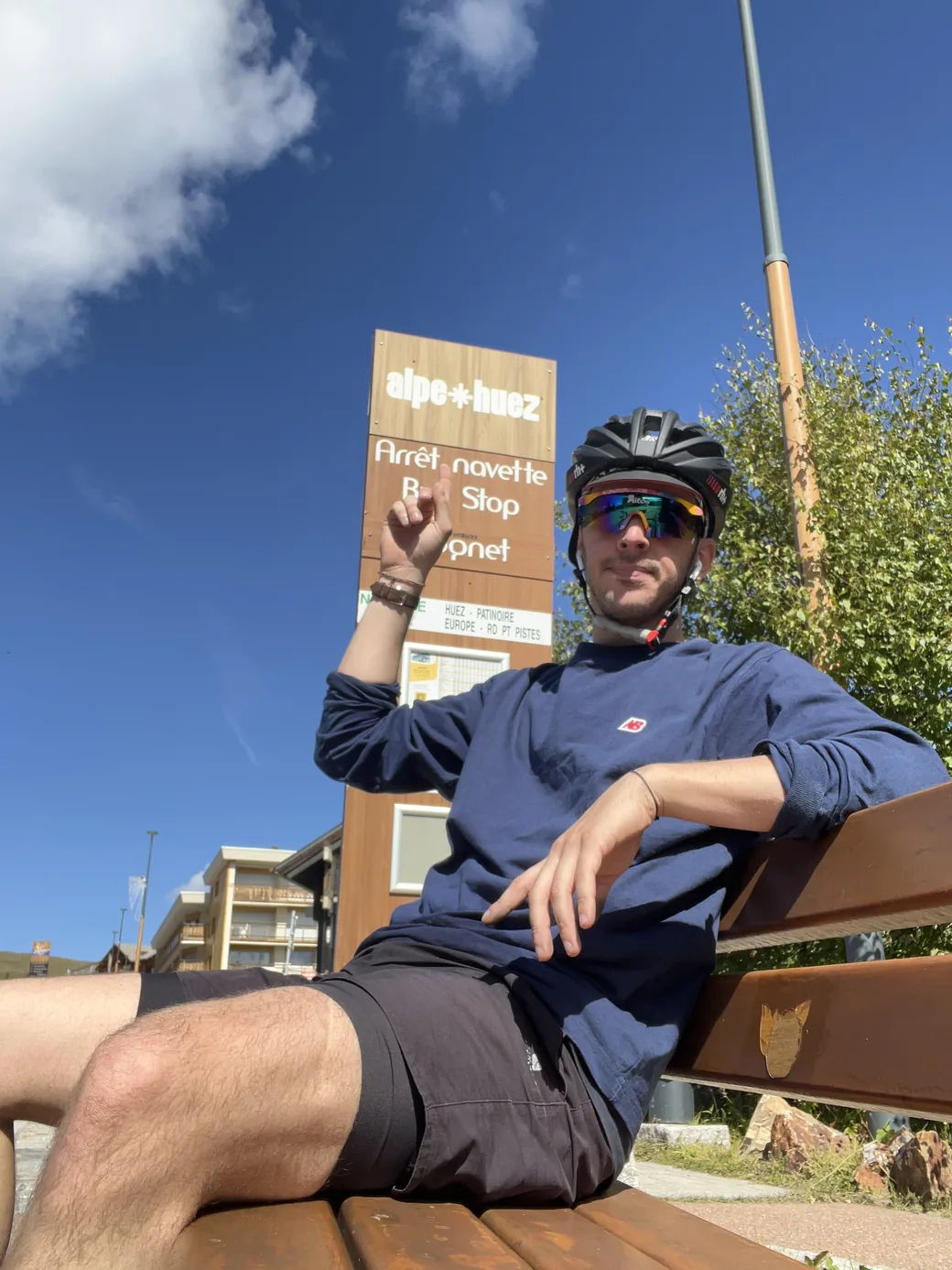 Erwan taking a break at Alpe d’Huez, wearing a cycling helmet